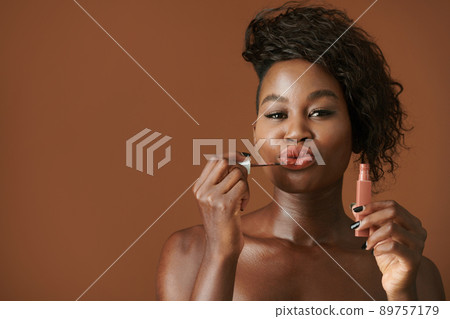 Woman Applying Liquid Lipstick Woman Applying Liquid Lipstick 89757179