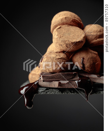 Chocolate truffles and falling drops of chocolate sauce. Chocolate truffles and falling drops of chocolate sauce. 89757310
