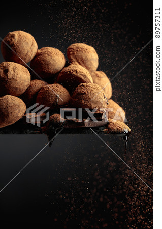 Chocolate truffles sprinkled with cocoa powder. Chocolate truffles sprinkled with cocoa powder. 89757311