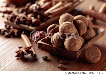 Chocolate truffles on a wooden table. Chocolate truffles on a wooden table. 89757312