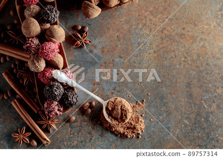 Chocolate truffles and spoon with cocoa powder. Chocolate truffles and spoon with cocoa powder. 89757314