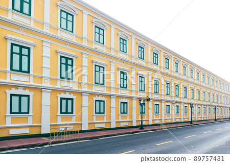 Yellow building with green window in vintage style on day with clear sky Yellow building with green window in vintage style on day with clear sky 89757481