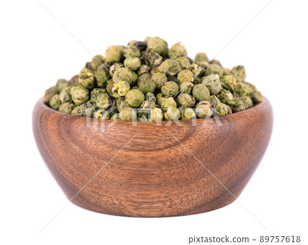 Green peppercorns in wooden bowl, isolated on white background. Organic spice. Dry green pepper grain. Green peppercorns in wooden bowl, isolated on white background. Organic spice. Dry green pepper grain. 89757618