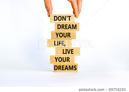 Live your dreams symbol. Wooden blocks with words Do not dream your life, live your dreams. Beautiful white background. Businessman hand. Business and live your dreams concept. Copy space. Live your dreams symbol. Wooden blocks with words Do not dream your life, live your dreams. Beautiful white background. Businessman hand. Business and live your dreams concept. Copy space. 89759285