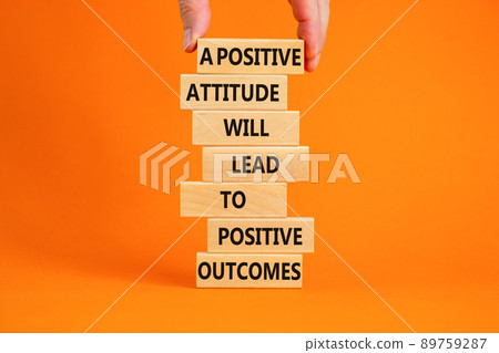 Think positive symbol. Wood blocks with words A positive attitude will come to positive outcomes. Orange background copy space. Businessman hand. Business motivational think positive concept. Think positive symbol. Wood blocks with words A positive attitude will come to positive outcomes. Orange background copy space. Businessman hand. Business motivational think positive concept. 89759287