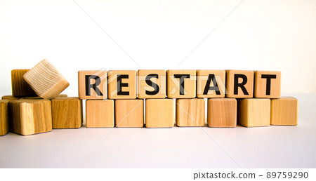 Restart and start symbol. The concept word Restart on wooden cubes. Beautiful white table, white background, copy space. Business restart and start concept. Restart and start symbol. The concept word Restart on wooden cubes. Beautiful white table, white background, copy space. Business restart and start concept. 89759290