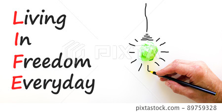 LIFE living in freedom everyday symbol. Concept words LIFE living in freedom everyday on beautiful white background. Businessman hand. Business LIFE living in freedom everyday concept. Copy space. LIFE living in freedom everyday symbol. Concept words LIFE living in freedom everyday on beautiful white background. Businessman hand. Business LIFE living in freedom everyday concept. Copy space. 89759328