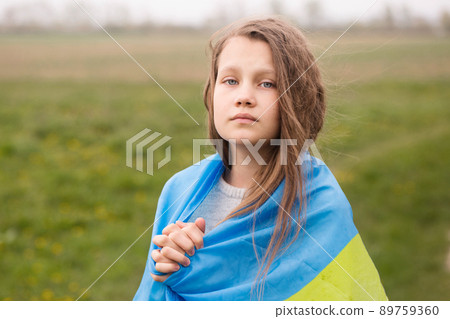Little Ukrainian girl with the flag of Ukraine 89759360