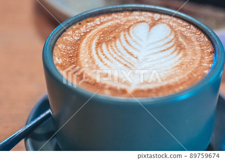 A cup of coffee latte top view with leaf shape foam A cup of coffee latte top view with leaf shape foam 89759674