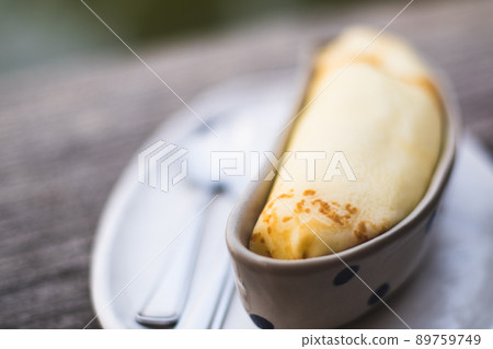 Banana crepe sweet dessert object still life. The crepe put in the ceramic container bowl banana shape form design. 89759749