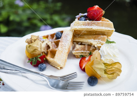 Homemade breakfast Strawberry and tropical fruits Waffles with chocolate syrup Homemade breakfast Strawberry and tropical fruits Waffles with chocolate syrup 89759754