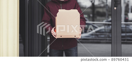 Delivery man employee hold empty cardboard box 89760431