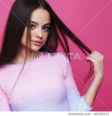 young pretty girl with brunette long hair posing cheerful on pink background, lifestyle people concept close up young pretty girl with brunette long hair posing cheerful on pink background, lifestyle people concept close up 89760513