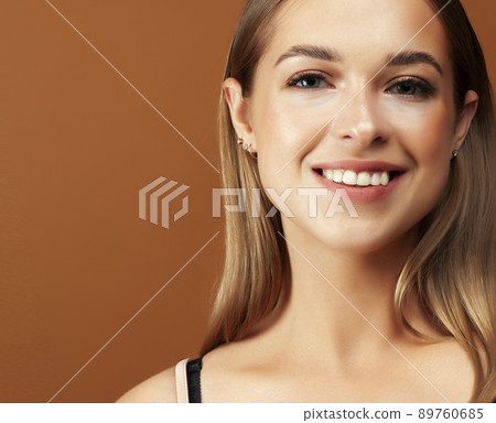 young pretty girl with blond hair posing cheerful on brown background, lifestyle people concept close up young pretty girl with blond hair posing cheerful on brown background, lifestyle people concept close up 89760685