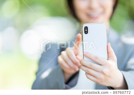 Female business woman parts in suits that use smartphones 89760772