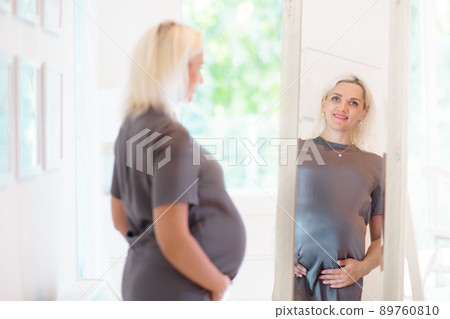 Pregnant woman at home. Young expecting mother. Pregnant woman at home. Young expecting mother. 89760810