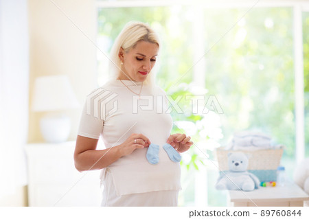Pregnant woman at home. Young expecting mother. 89760844