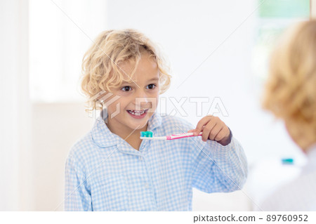 Child brushing teeth. Kids with toothpaste, brush. 89760952