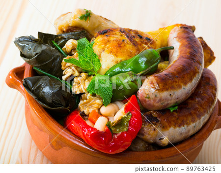 Kapama a dish of bulgarian cuisine with assortiment meat, grape rolls 89763425