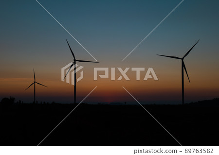 wind turbine field at beautiful sunset sky background. renewable energy wind turbine field at beautiful sunset sky background. renewable energy 89763582