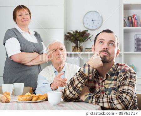 Parents arguing with son 89763717