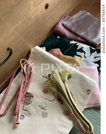Kimono and accessories in front of a paulownia chest 89766654