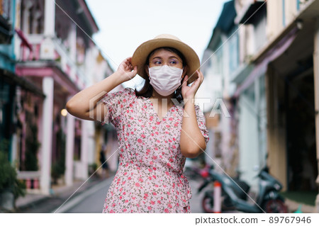 Travelers with mask walking on street Phuket old town with Building Sino Portuguese architecture at Phuket Old Town area Phuket, Thailand. Travel concept and summer trip. 89767946