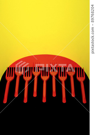 Abstract still life with red forks on a colored background Abstract still life with red forks on a colored background 89768204