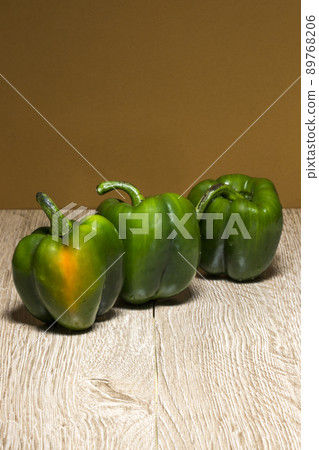 Still life with three green sweet peppers 89768206