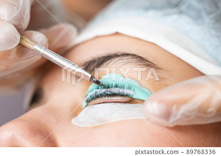 Close-up portrait of a woman on eyelash lamination procedure.  89768336