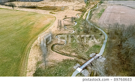 Aerial view in springtime with a trail and spiraling river Aerial view in springtime with a trail and spiraling river 89768683