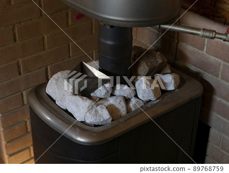 Hot quartz stone on heater in sauna spa room. 89768759