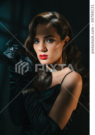 Portrait of a brunette woman in a classic retro style. A beautiful girl with a hairstyle and makeup with jewelry Hollywood film 89769131