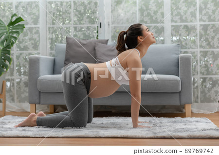 Happy Attractive Asian Pregnant woman practice Cat Cow Pose to meditation smile with big belly in the morning comfortable and relax,Pregnancy woman breathing and calm with yoga,Yoga Pregnant Concept Happy Attractive Asian Pregnant woman practice Cat Cow Pose to meditation smile with big belly in the morning comfortable and relax,Pregnancy woman breathing and calm with yoga,Yoga Pregnant Concept 89769742