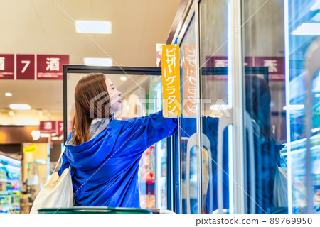 Housewife buying frozen food at the supermarket Housewife buying frozen food at the supermarket 89769950