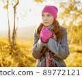 Young woman walking in the fall season. Autumn outdoor portrait 89772121