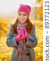 Young woman enjoying the fall season. Autumn outdoor portrait 89772123