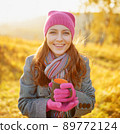 Young woman enjoying the fall season. Autumn outdoor portrait 89772124