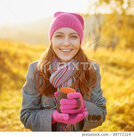 Young woman enjoying the fall season. Autumn outdoor portrait 89772124