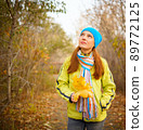 Young woman walking in the fall season. Autumn outdoor portrait 89772125