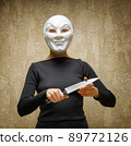 Woman in white mask holding the knife 89772126