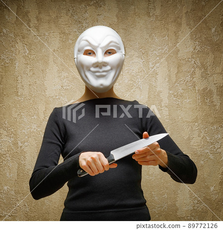 Woman in white mask holding the knife 89772126