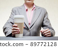 Business woman with a tumbler of coffee 89772128