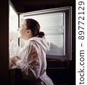 Young woman looking for some snack in fridge late at night 89772129