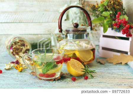 Vitamin tea made from berries, healthy herbs, lemon in glass cups and a teapot on a light background Vitamin tea made from berries, healthy herbs, lemon in glass cups and a teapot on a light background 89772633