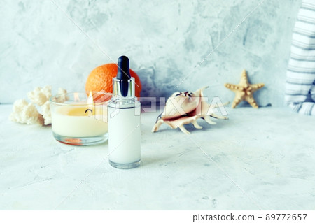Cream gel, sea shells and a burning candle, orange, spa, ingredients for a cosmetic mask on a wooden table, body care 89772657