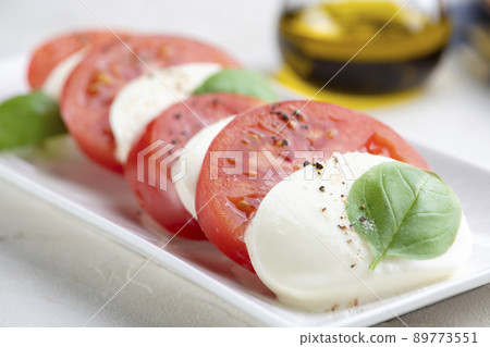 Caprese of fresh tomatoes and mozzarella cheese Caprese of fresh tomatoes and mozzarella cheese 89773551