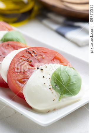 Caprese of fresh tomatoes and mozzarella cheese Caprese of fresh tomatoes and mozzarella cheese 89773553