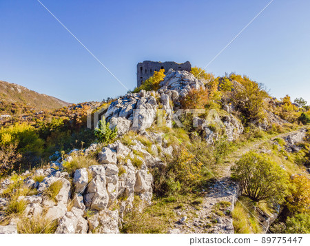 Collapsing tower of fortress Kosmac. Ancient Austro-Hungarian fortress built as a defensive structure and an observation post. Montenego Collapsing tower of fortress Kosmac. Ancient Austro-Hungarian fortress built as a defensive structure and an observation post. Montenego 89775447