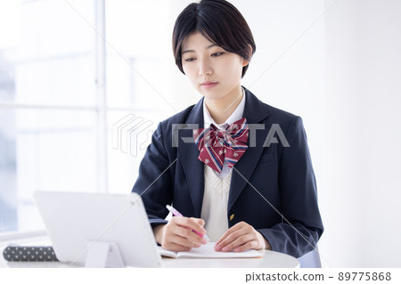 Student high school girl studying on a tablet Student high school girl studying on a tablet 89775868